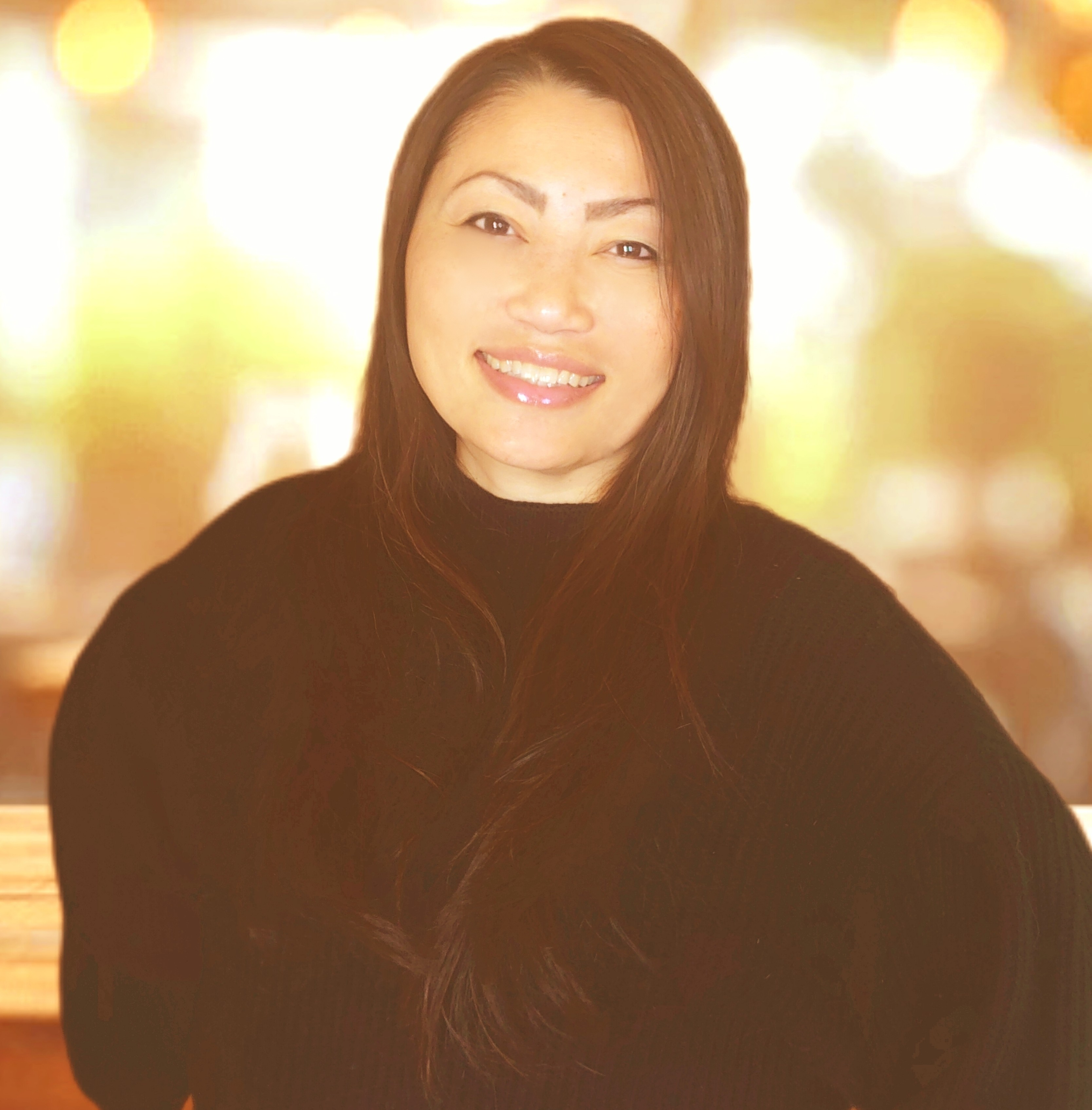 Maliaj Yang, smiling, in a black sweater